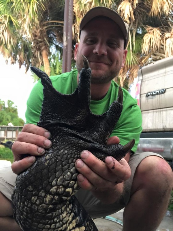 Bryan with his Alligator Hunt harvest.  A giant alligator claw.